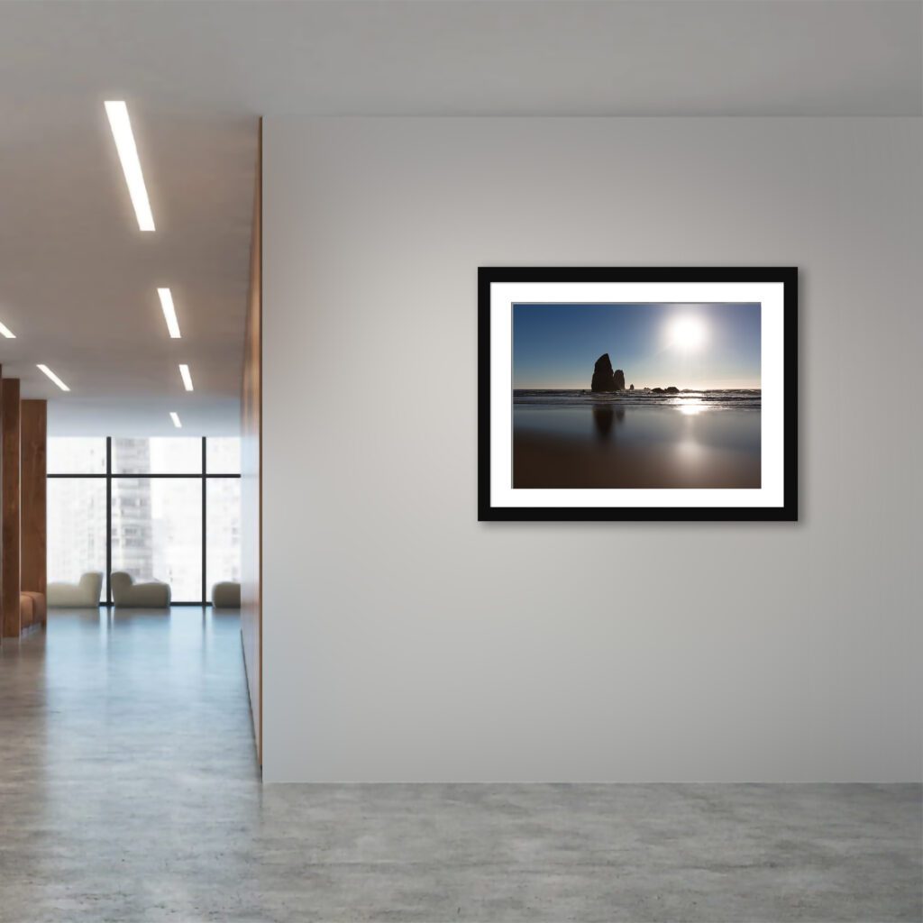 Experience the raw grandeur of Canon Beach, Oregon through this evocative portrayal of dramatic rock monoliths reflecting in the dark, wet sands.