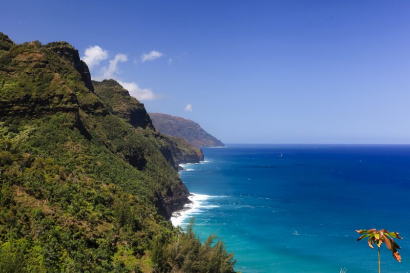 Experience the majestic Napali Coast, where towering mountains gracefully descend to meet the tranquil Pacific