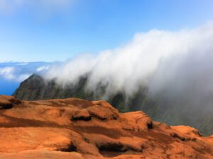 Experience a serene sky theatre as clouds dance gracefully over the majestic Koke’e Mountains, bringing a tranquil panorama alive in your living space.