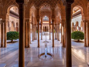 A captivating glimpse into the heart of Alhambra’s Nasrid Palace, embodying tranquility and architectural brilliance.