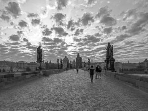 This print encapsulates the serene aura of Charles Bridge, Prague, during the early morning, showcased in beautiful black and white tones.