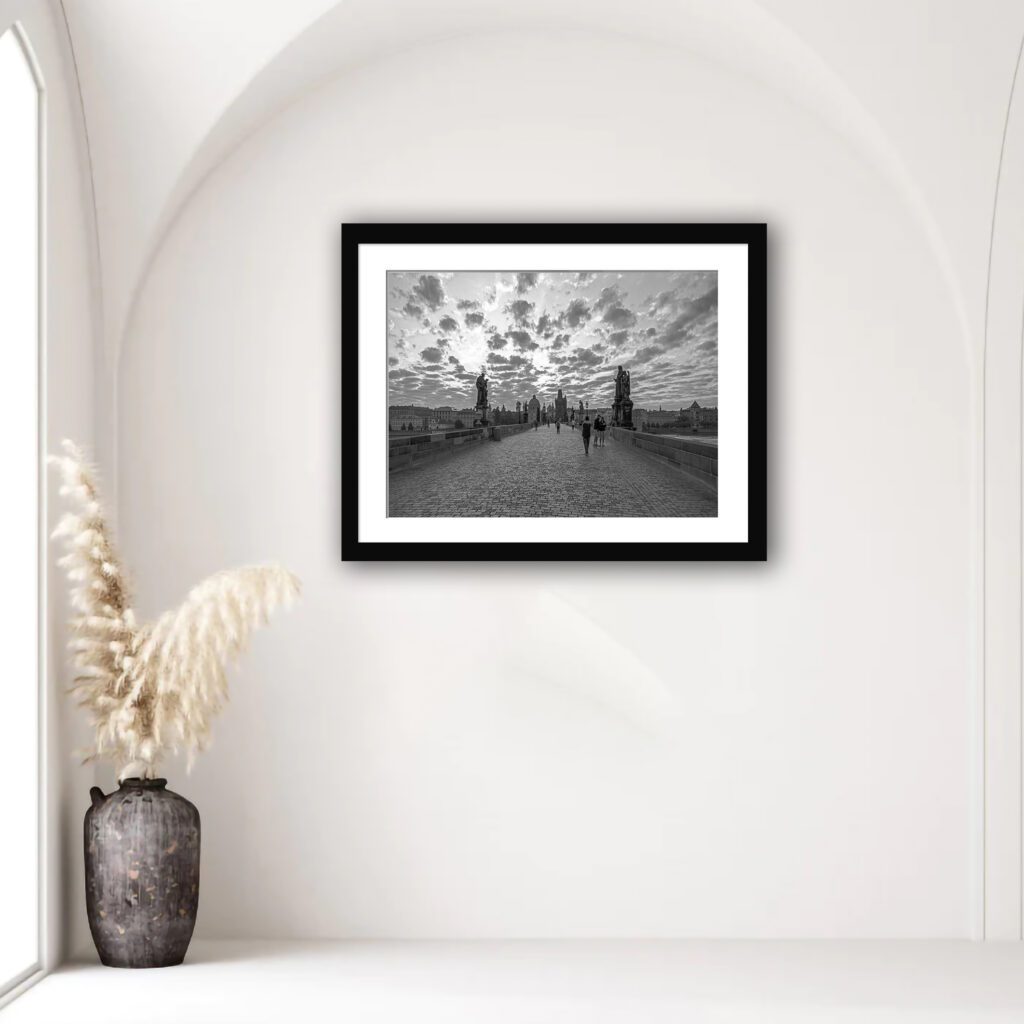 This print encapsulates the serene aura of Charles Bridge, Prague, during the early morning, showcased in beautiful black and white tones.