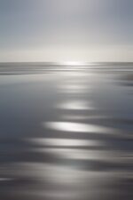 Dive into the mesmerizing canvas where the sun paints intense silver patterns across the Oregon sands and distant waves.