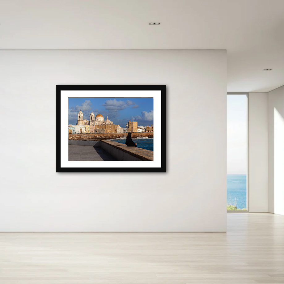 This striking image portrays a solitary figure amidst the historic beauty of Cadiz, offering a tale of reflection and timelessness.