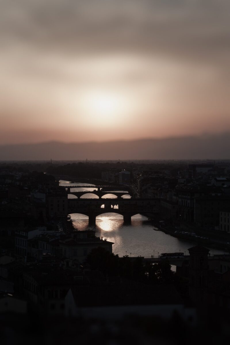 Florence bridges at sunset with glowing Arno River