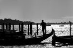 Gondolier silhouette against Venice sunset