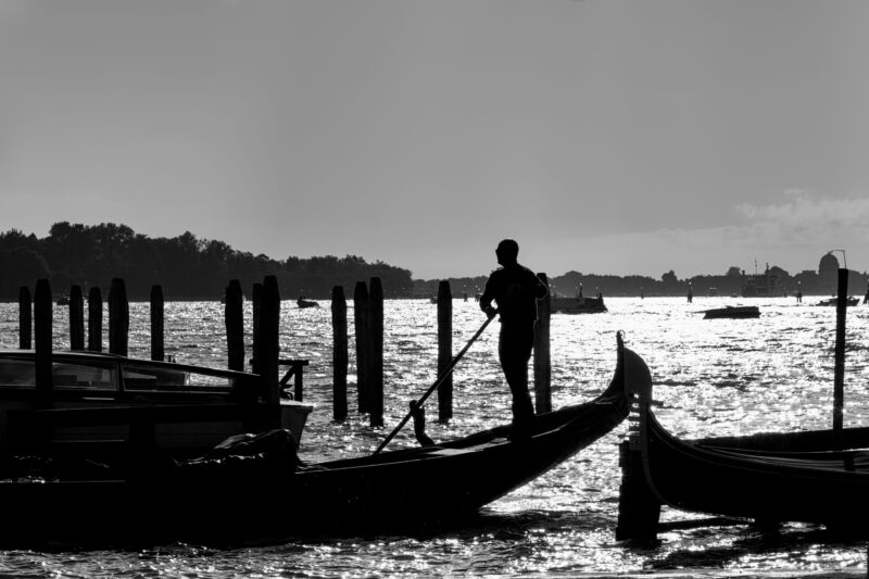 Gondolier silhouette against Venice sunset
