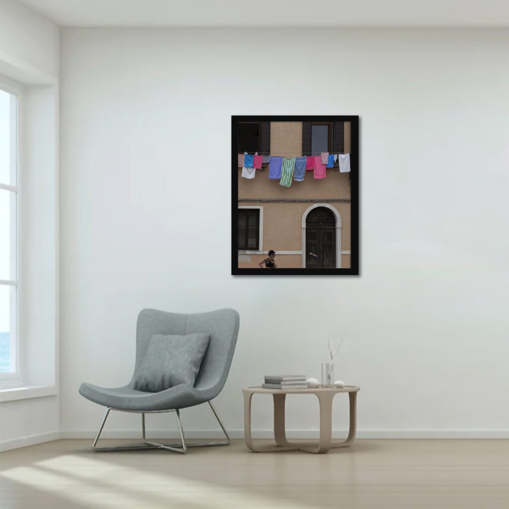 Venetian building with hanging laundry and a passerby