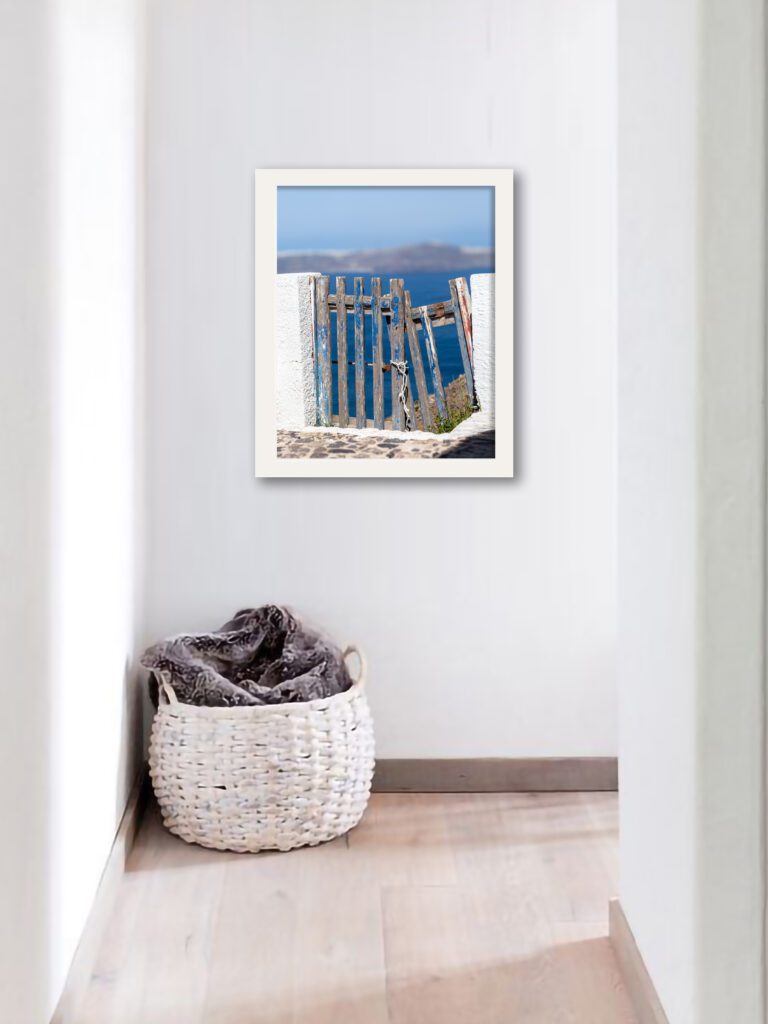 Weathered blue wooden fence with ocean view in Santorini, Greece.